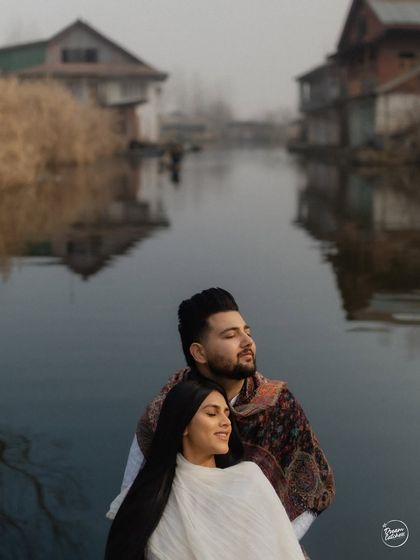A close-up of a couple enjoying a quiet moment in a shikara on Dal Lake. The soft light and calm water create a dreamy, romantic atmosphere for this intimate portrait.