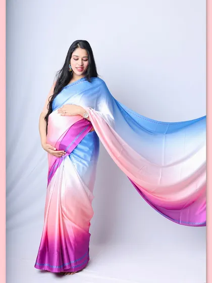 Celebrating tradition with a modern twist. This stunning ombre saree creates a graceful and colorful look, perfect for a maternity shoot that honors your desi roots.
