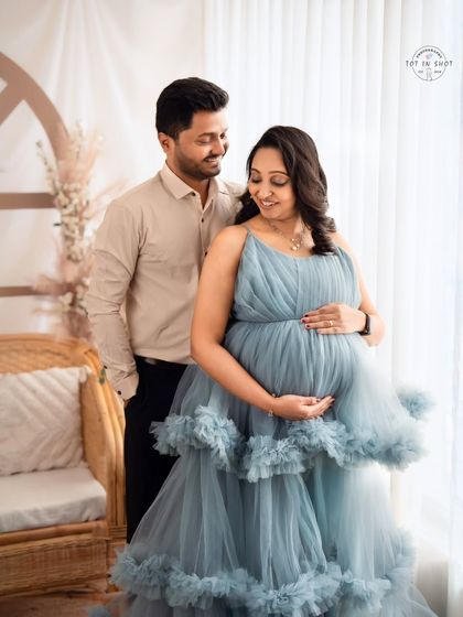 A sweet couple's portrait by the window, using soft natural light to create a gentle and romantic mood.