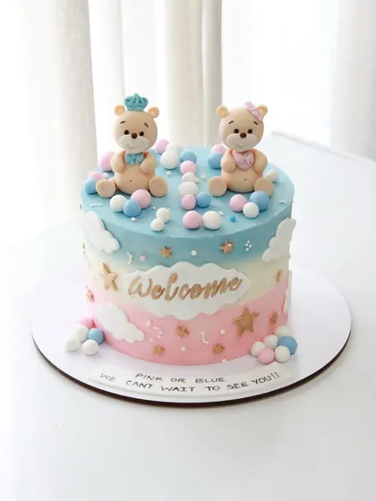 Another sweet gender reveal cake with a "Welcome" message. The pink and blue pastel theme with cute teddy bear toppers builds excitement for the big surprise.