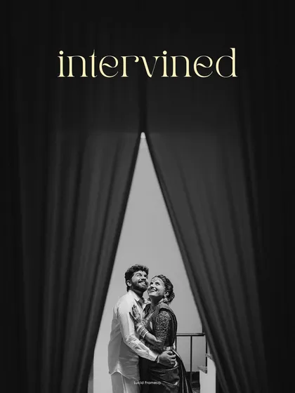 "Intertwined." A dramatic black and white portrait of a couple framed by curtains, creating a theatrical and cinematic feel.