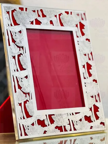 The lotus is a symbol of purity and beauty, and I love using it in my designs. This elegant silver frame features a delicate lotus flower cutout pattern against a rich red velvet background.