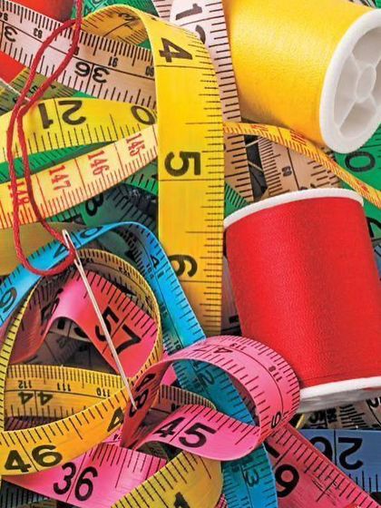 Work in progress. A collection of measuring tapes and colorful threads, the essential tools of my trade, ready to bring new designs to life.