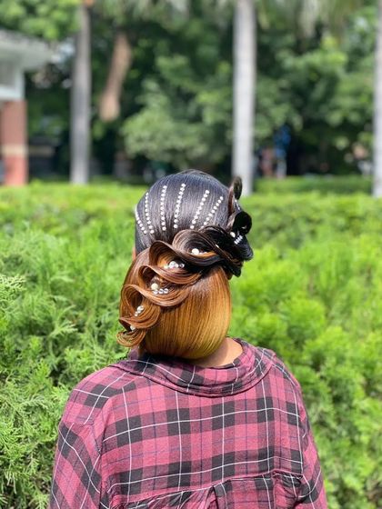 The final result of the modern updo, decorated with pearl and crystal accessories. This is a great example of a non-traditional hairstyle for a fashion-forward client.