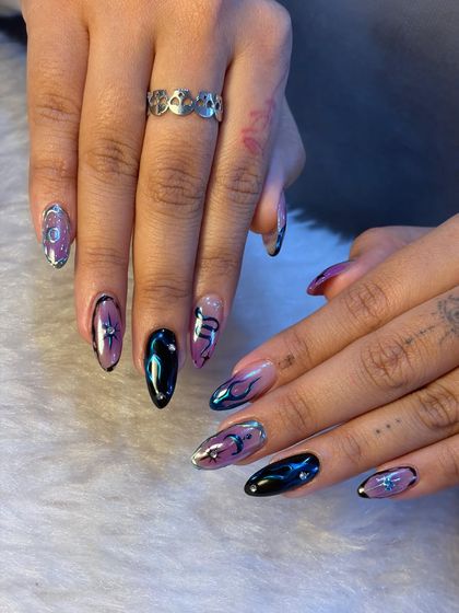 This edgy and trendy set showcases our expertise in chrome nail art. The combination of different designs on each nail creates a unique and personalized look that is sure to turn heads.