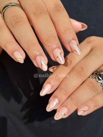 Trending nails alert! These chrome line-art nails are super chic and modern. The metallic silver swirls on a nude base create a sleek, futuristic look.