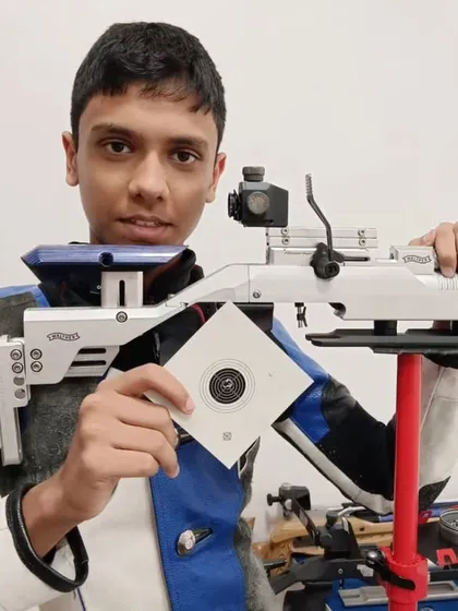 Our 13-year-old shooter Shiven Kumar during a training session at our Delhi branch, holding his target with pride.