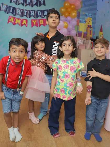 Friends gathered for a birthday photo. Notice the temporary Spider-Man tattoo, one of the fun add-ons available with our party packages.