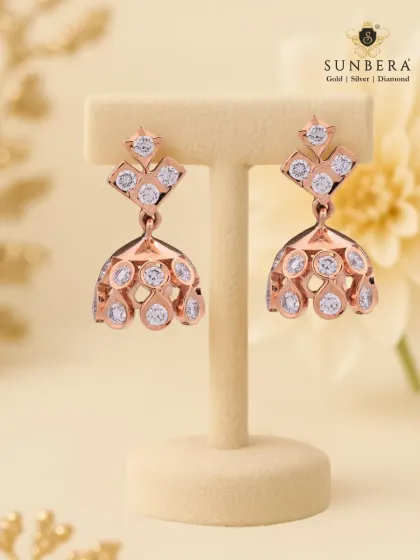 Modern jhumka-style earrings crafted in rose gold and studded with diamonds. The design offers a contemporary twist on a traditional favourite, perfect for festive occasions and parties.