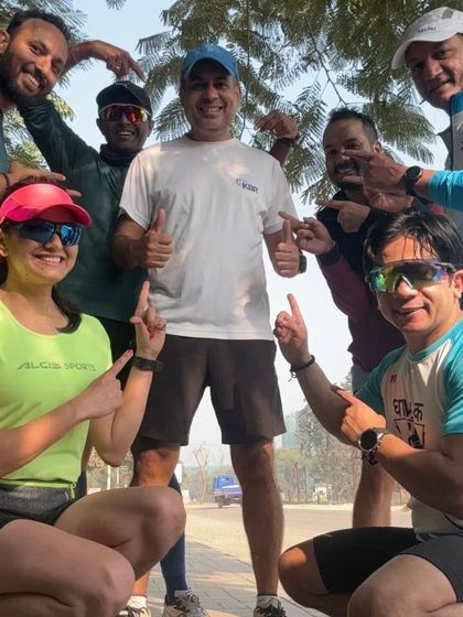 A group of smiling runners pointing to me during a promo run for the IPA Neerathon. Running for a cause like water conservation brings our community even closer.