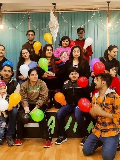 A happy moment captured during a New Year's party at the studio. The tiered seating and open floor can comfortably accommodate groups for celebrations, making everyone feel part of the fun.