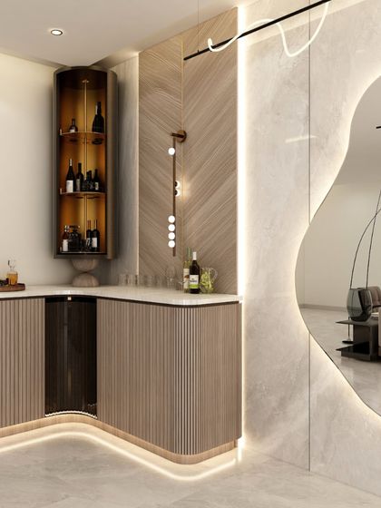 A closer look at the custom bar unit, with its curved form, under-counter lighting, and a mix of open and closed storage for a functional yet stylish setup.