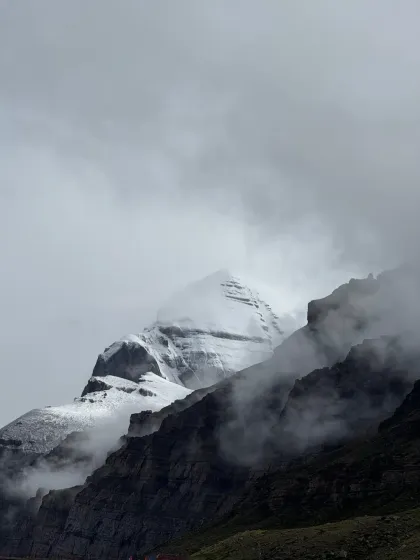 The sacred Mount Kailash, veiled in mist and cloud. To be in its presence is not a destination to be reached, but a grace to be received. This is the heart of our yatra, a moment of profound stillness and darshan.