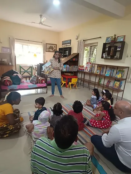 The storyteller stands to command the room, ensuring all children can see and hear the story of the kind giant.
