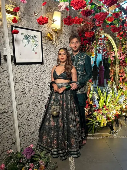 A beautiful portrait of the couple at their Mehendi, surrounded by decor that reflects their personalities. The floral arrangements and personal photos made the event feel intimate and special.