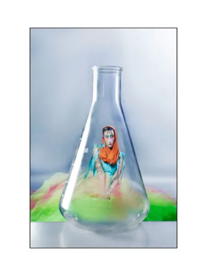The narrative culminates with the model enclosed within a laboratory flask, a direct visual metaphor for being a product of chemical reactions. This shot encapsulates the entire conceptual photoshoot.