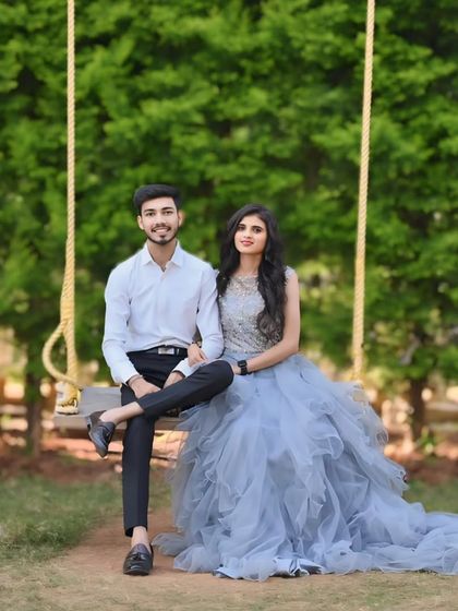 A fairytale moment on a swing. This grey gown features an embellished bodice and an asymmetric, layered tulle trail for a romantic and dreamy look.