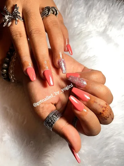 Another view of the long coral and glitter acrylic extensions. This angle shows off the sleek shape and the beautiful shine of the gel polish and glitter.