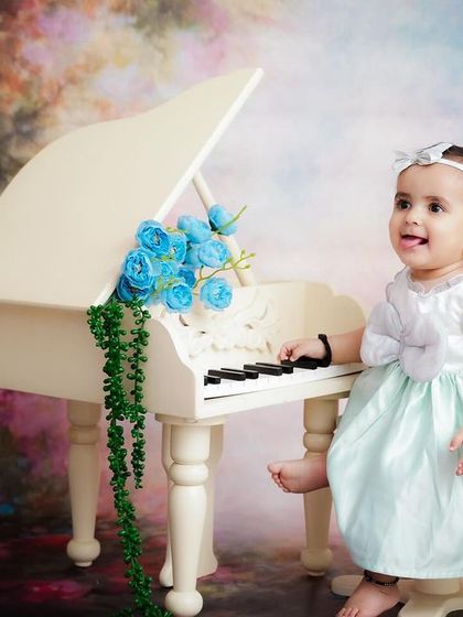 Another delightful shot of our little pianist, capturing a different, happy expression as she explores the miniature piano.