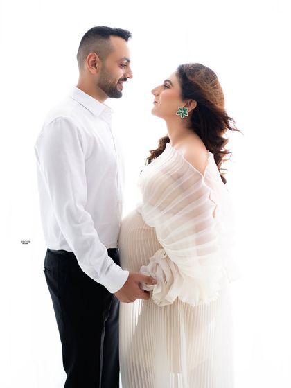 A classic pose, holding hands and looking at each other. You can feel the deep connection and love between them.