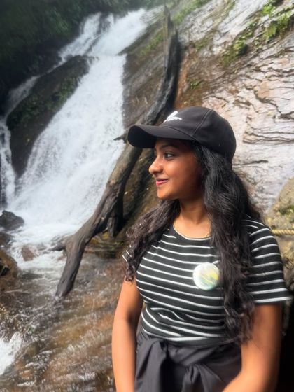 A trekker enjoying a quiet moment by a smaller cascade on the way to the main Hidlumane Falls.