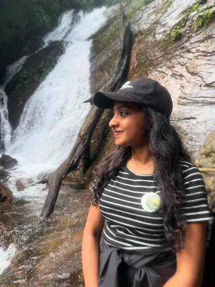 A trekker enjoying a quiet moment by a smaller cascade on the way to the main Hidlumane Falls.