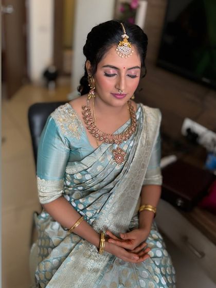 A close-up of Jahnavi's naming ceremony makeup. The skin is fresh and dewy, and the eye makeup is soft and subtle.