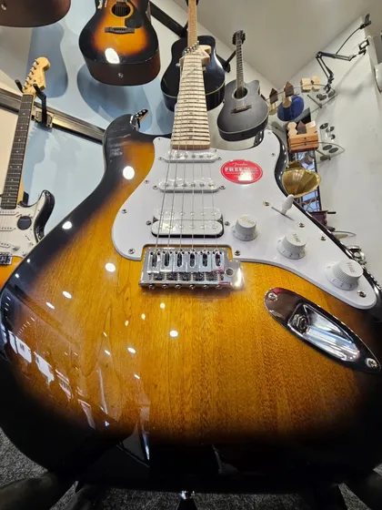 The iconic Fender FSR Stratocaster HSS in a timeless 2-Tone Sunburst finish. This close-up shows the beautiful wood grain and classic design that has defined generations of music. It represents the perfect blend of vintage feel and modern versatility we stock.
