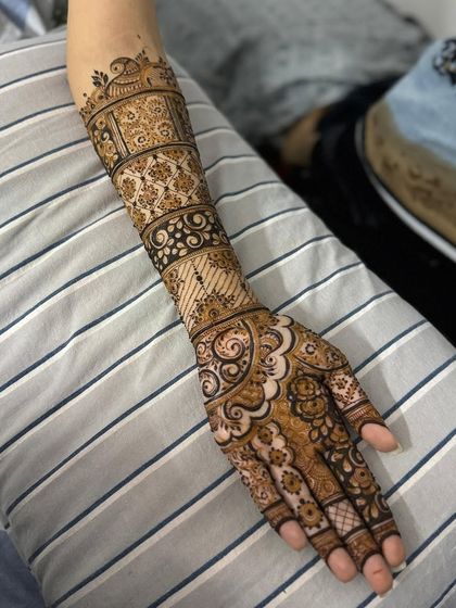 This view shows the full length of the arm, from the fingertips to the elbow, covered in a traditional banded pattern.