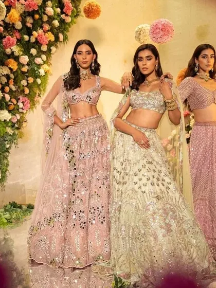 A group shot of three models in coordinated pastel lehengas, showing the versatility of this color palette.