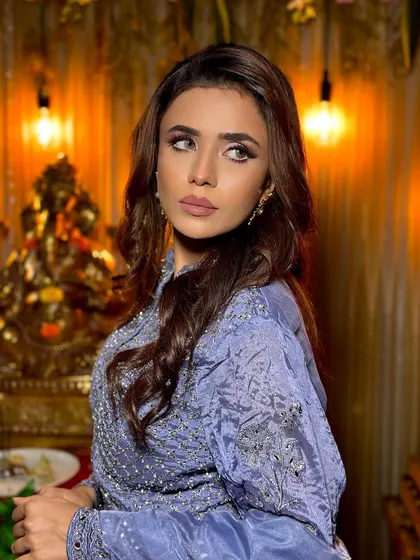 Another angle of this high-glam look. The makeup is sculpted and defined, perfect for photoshoots or red-carpet events.