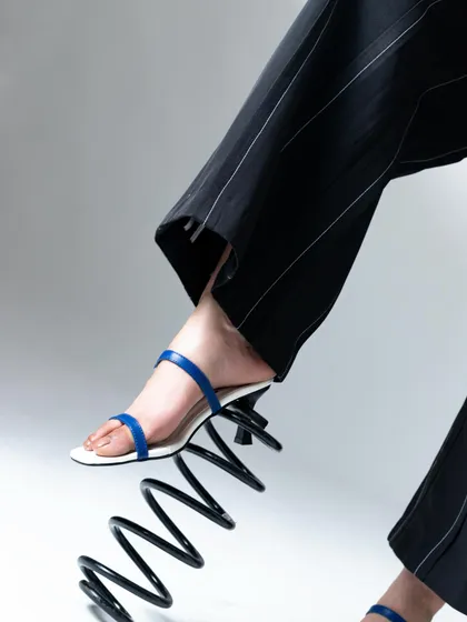 Getting creative with props. This giant spring added a playful and unexpected element to the footwear shoot.