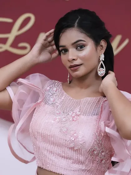 A close-up portrait showing the soft makeup and the fluttery sleeves of the dress, creating a very feminine and ethereal vibe.