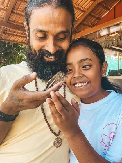A moment of gentle connection between humans and nature. I show a small bird to a young student, sharing a lesson in kindness and reverence for all living creatures.