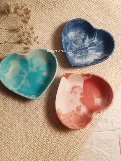 Our mini heart-shaped dishes in various marbled colors. These are perfect for holding a single piece of jewelry, like your wedding ring, by the sink or on your nightstand.