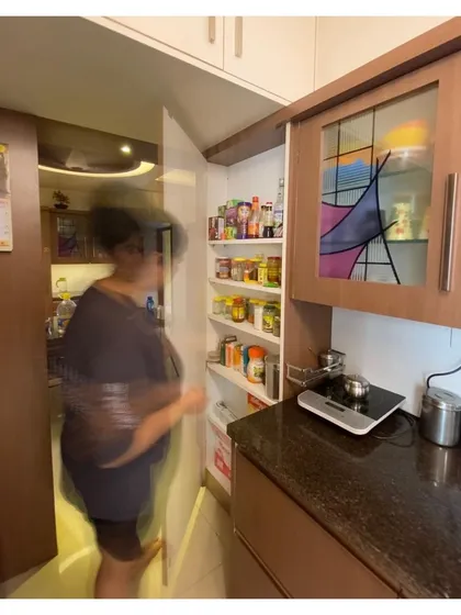 We excel at creating clever storage solutions for small apartments. This pull-out pantry provides significant storage capacity while maintaining a seamless look when closed.
