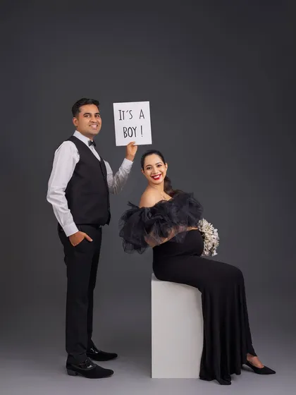 A classic and joyful gender reveal. The simple "It's a Boy!" sign combined with their happy expressions makes for a perfect announcement photo.
