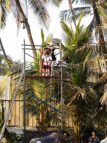 An exciting zip line setup among the palm trees provides a thrilling adventure for party guests.