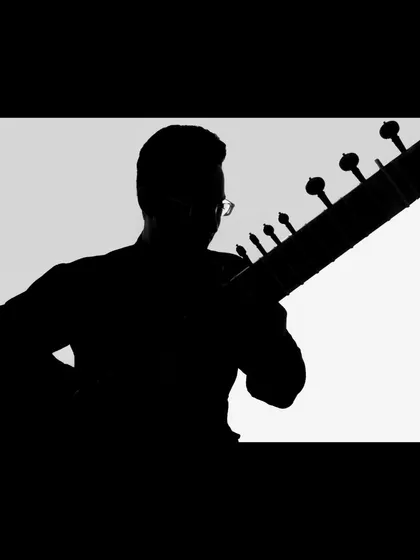 A creative silhouette shot, highlighting the iconic shape of the sitar and the artist. This modern photographic style adds a unique touch to my portfolio.