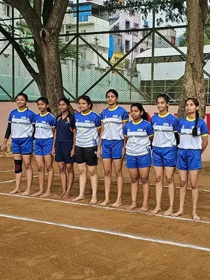 Our girls' Kabaddi team lined up and ready for action on the dirt court.