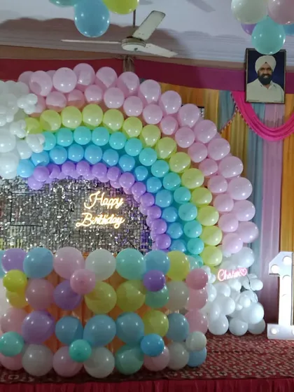 A vibrant and cheerful rainbow theme, perfect for a child's first birthday. I constructed a full balloon rainbow arch against a silver shimmer backdrop, complete with a "Happy Birthday" neon sign and a large light-up '1' to mark the special day.