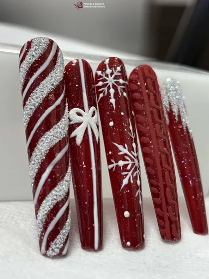 Another shot of the red and white Christmas nail art, showing the glitter and texture details up close.