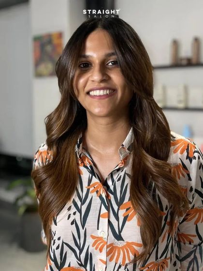 A happy client showing off her new warm balayage.