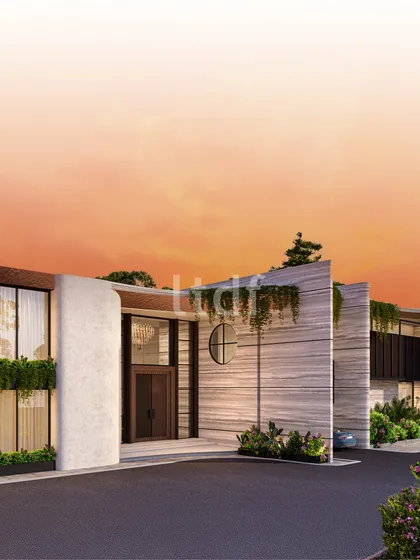 The facade of this home is defined by a unique blend of curved and linear forms. We used neutral stone textures, a circular window accent, and integrated planters to create an entrance that is warm, contemporary, and architecturally distinct.