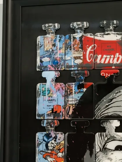 Detail of the top left corner of "Dali In A Bottle," featuring comic book art and Campbell's soup imagery within the bottle forms.