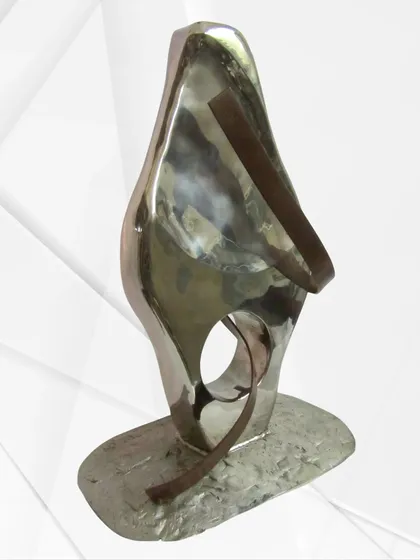 "The Lady," a throwback to an earlier work. This piece explores a feminine form using polished steel and contrasting bronze-toned bands.