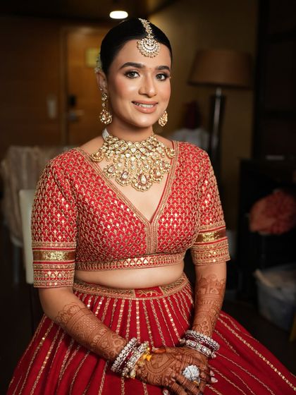 A full-length shot of the bride in her stunning red lehenga. I teach how to create a complete look that is cohesive from head to toe.