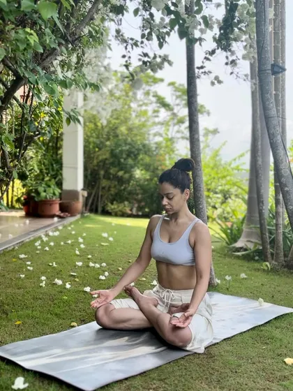 My practice in Padmasana (Lotus Pose) in a serene garden setting.