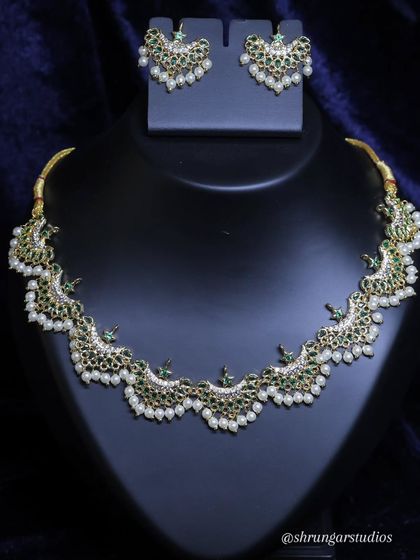 This premium Chandra necklace with green stones and pearls is a beautiful standalone piece.
