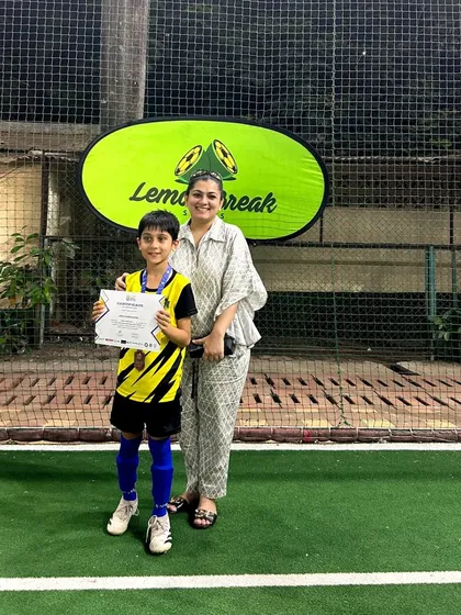 A proud player with his mom after being felicitated for his participation in the U-9 league. The support of our parents is a huge part of our success.